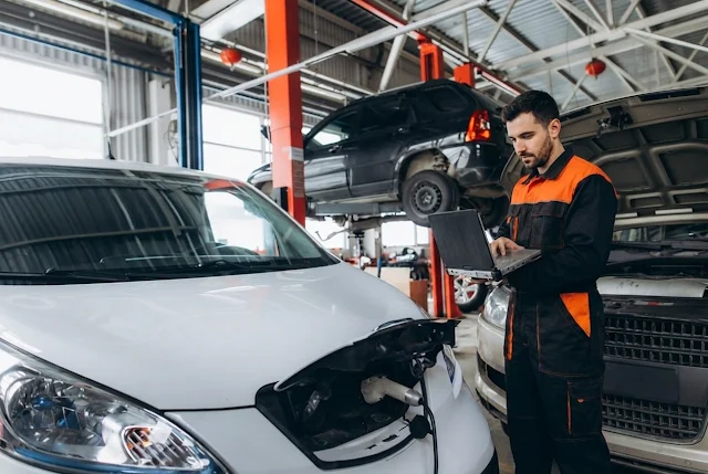 Coche eléctrico en un taller con mecánico